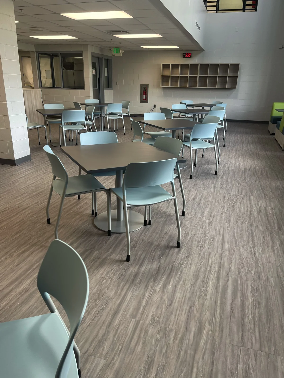 Café tables and light blue chairs in a shared area