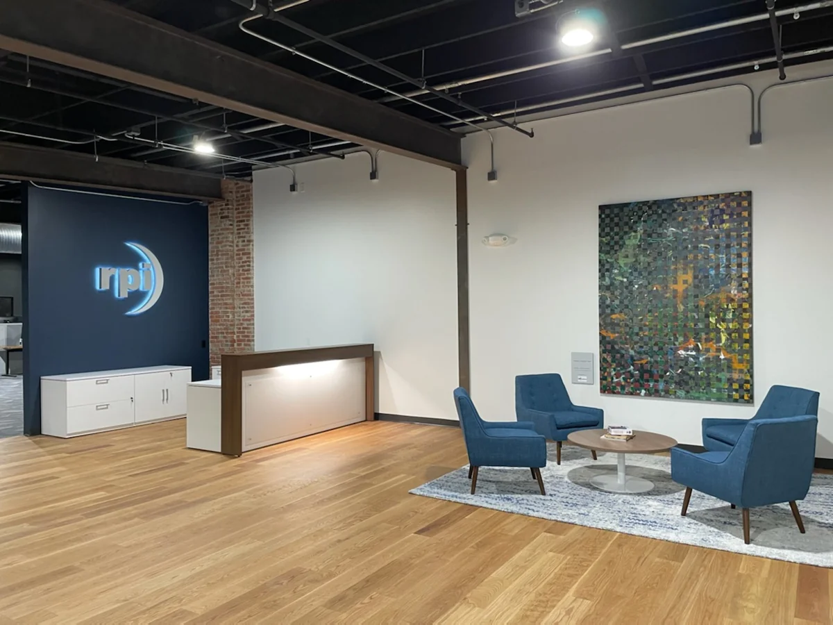 Reception counter and blue lounge chairs in a commercial interior