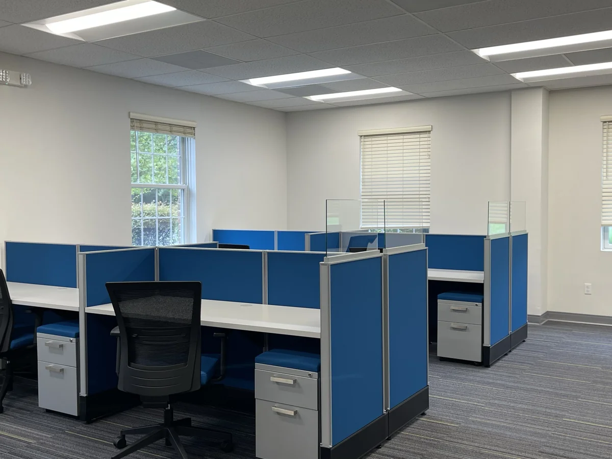Blue-panel workstations with task chairs and storage